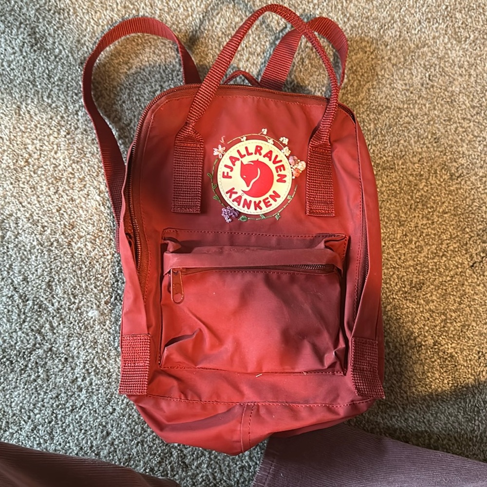 Mini red fjallraven backpack. I embroidered it myself :)